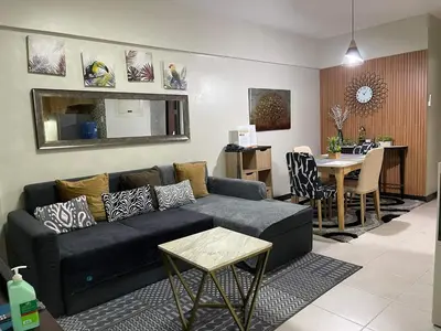 a living room with a couch and a table at MaRoy Suites at Asteria Residences (Near NAIA with free Parking+Fiber Internet) in Manila