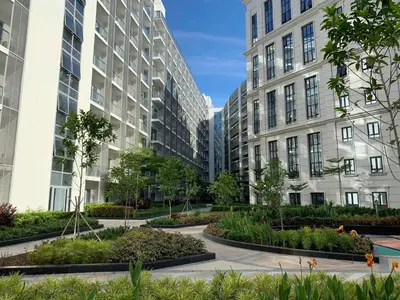two tall buildings with a courtyard with plants at Modern and Cozy Studio near Airport Terminal 3 in Manila
