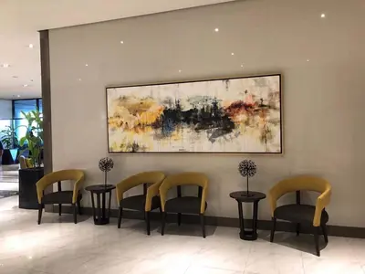 a waiting room with chairs and a painting on the wall at Modern and Cozy Studio near Airport Terminal 3 in Manila