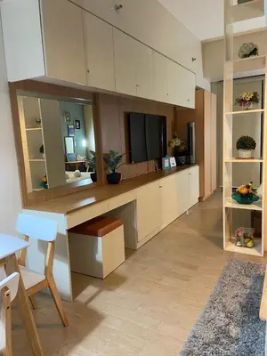 a living room with a desk with a tv at Modern and Cozy Studio near Airport Terminal 3 in Manila