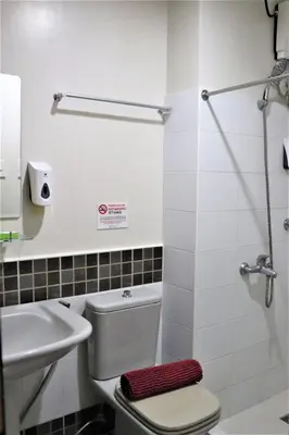 a bathroom with a toilet and a sink at The Studio 18 Residences in Manila