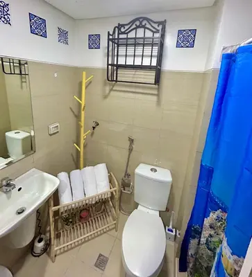 a bathroom with a white toilet and a sink at Santiorini at Shore Residences in Manila