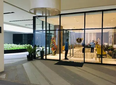 a lobby with people standing inside of a building at Studio Room Walking Airport, In City Of Newport City in Manila