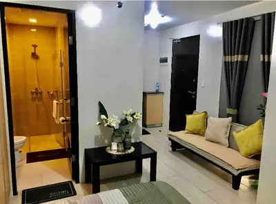 a living room with a couch and a bathroom at Studio Room Walking Airport, In City Of Newport City in Manila