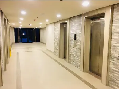 a hallway of a building with a door and a hallwayngth at Studio Room Walking Airport, In City Of Newport City in Manila