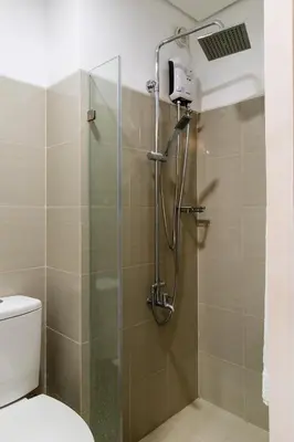a bathroom with a shower with a glass door at Luxury condo At Shore 1 Tower C1, Mall of Asia Complex Pasay City in Manila
