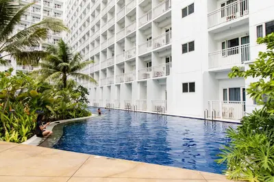 a swimming pool in the courtyard of a building at Luxury condo At Shore 1 Tower C1, Mall of Asia Complex Pasay City in Manila