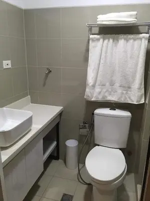 a bathroom with a white toilet and a sink at Luxury condo At Shore 1 Tower C1, Mall of Asia Complex Pasay City in Manila
