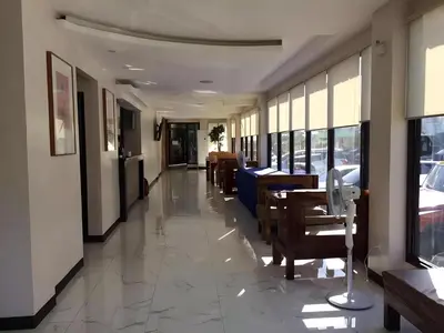 a corridor of a restaurant with tables and chairs at OYO 195 Ranchotel - Biñan in Biñan