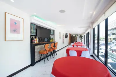 a row of red tables and chairs in a restaurant at OYO 195 Ranchotel - Biñan in Biñan