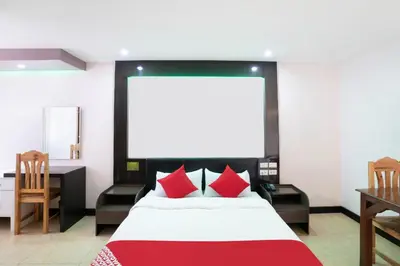 a bedroom with a large bed with red pillows at OYO 195 Ranchotel - Biñan in Biñan