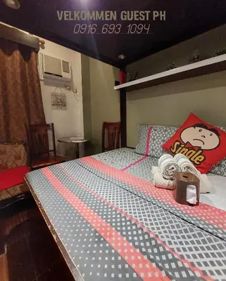 a bedroom with a bed with a hello kitty pillow and towels at NAIA Airport Fasanvej Studio condo NetflixTv 4pax in Manila