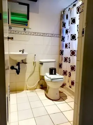 a bathroom with a toilet and a sink at NAIA Airport Fasanvej Studio condo NetflixTv 4pax in Manila