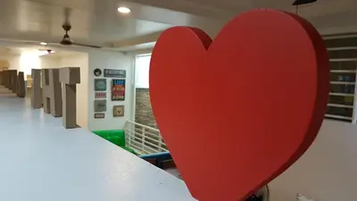 a large red heart on a table in a room at Crossroads Hostel Manila in Manila