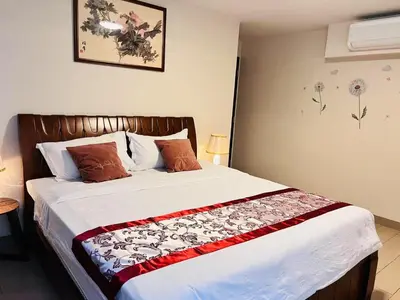 a bedroom with a large bed in a room at ONE UPTOWN \uff08BGC\uff09 in Manila
