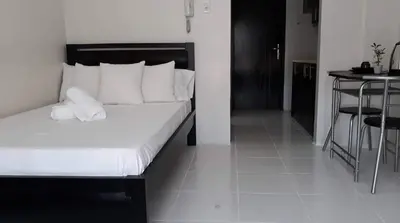a bedroom with a bed with white sheets and pillows at Cozy Studio @ One Capitol Condo 2nd St. Kapitolyo in Manila