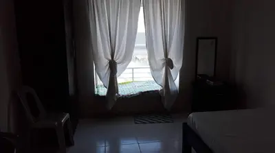 a bedroom with a window with a bed and a chair at Cozy Studio @ One Capitol Condo 2nd St. Kapitolyo in Manila