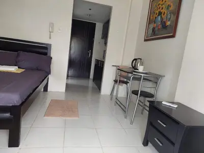 a living room with a bed and a table at Cozy Studio @ One Capitol Condo 2nd St. Kapitolyo in Manila