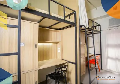 a room with a bunk bed and a ladder at The City Flats Amorsolo in Manila