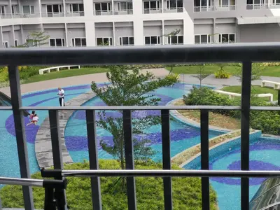 a view of the pool from the balcony of a hotel at SMDC GRACE RESIDENCIES in Manila