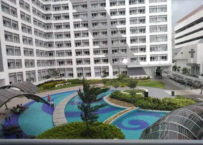 a large apartment building with a large swimming pool at SMDC GRACE RESIDENCIES in Manila
