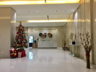 a christmas tree in the middle of a lobby at Condo 101 Newport in Manila