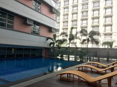 a swimming pool in front of a building at Condo 101 Newport in Manila