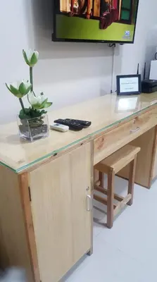 a wooden desk with a tv on top of it at Condo 101 Newport in Manila