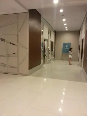 a woman standing in a hallway in a building at The Beacon 1BR for 4, T2, WIFI 300Mbps in Manila