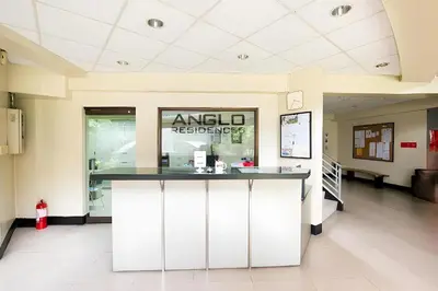 a lobby with a counter in the middle of a building at Anglo Residences Manila in Manila