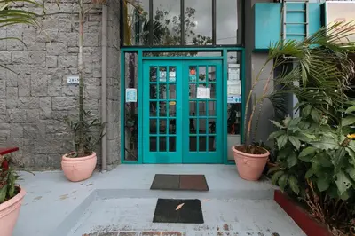 a blue door with plants in front of a building at RedDoorz Plus at BGC near St Lukes in Manila