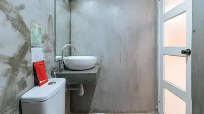 a bathroom with a sink and a toilet at RedDoorz Plus at BGC near St Lukes in Manila