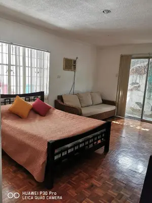 a bedroom with a bed and a couch at Casa Meyer's BF Homes International House for rent with pool and Jacuzzi in Manila
