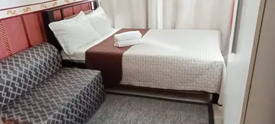 a small room with a bed and a chair at AZURE C4 BEACHPOOL balcony wifi MULTIPLE UNITS in Manila