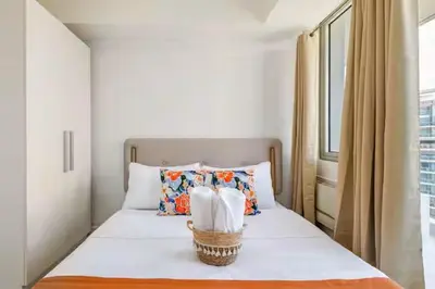 a bedroom with a bed with two towels on it at Sabrina'sCrib Apartment 2BR by Azure Residences Near Manila International Airport in Manila