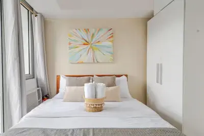 a bedroom with a bed with two towels on it at Sabrina'sCrib Apartment 2BR by Azure Residences Near Manila International Airport in Manila