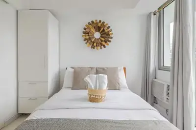 a bedroom with a bed with a wicker basket on it at Sabrina'sCrib Apartment 2BR by Azure Residences Near Manila International Airport in Manila