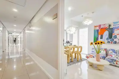 a living room with a table and a vase of flowers at Sabrina'sCrib Apartment 2BR by Azure Residences Near Manila International Airport in Manila