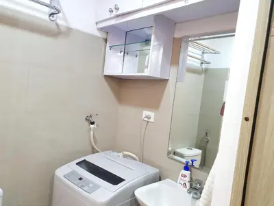 a small bathroom with a toilet and a sink at Condominium Shore 1 Mall of Asia in Manila