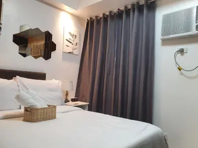 a bedroom with a white bed and a window at Condominium Shore 1 Mall of Asia in Manila