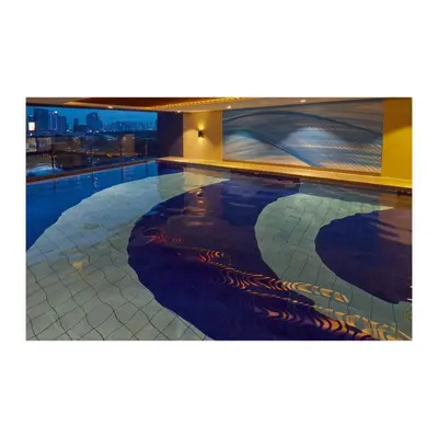 a swimming pool with a painting on the side of a building at Summit Hotel Greenhills in Manila