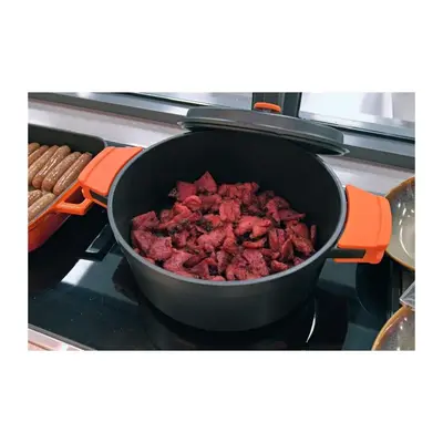 a pot of meat is cooking on a stove at Summit Hotel Greenhills in Manila