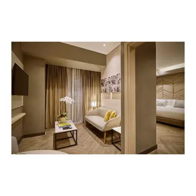 a living room with a couch and a bed at Summit Hotel Greenhills in Manila