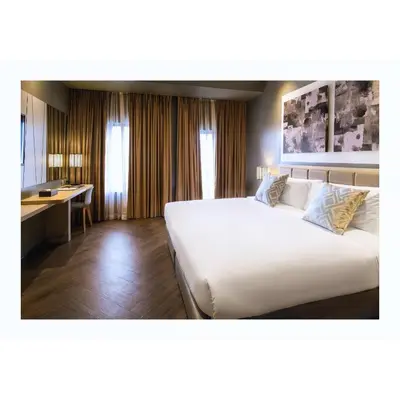 a hotel room with a large bed and a desk at Summit Hotel Greenhills in Manila