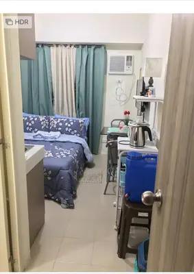 a hospital room with a bed and a table at Shanilyn Residency Urban Deca Towers EDSA mandaluyong Unlimited INTERNET AND NETFLIX in Manila