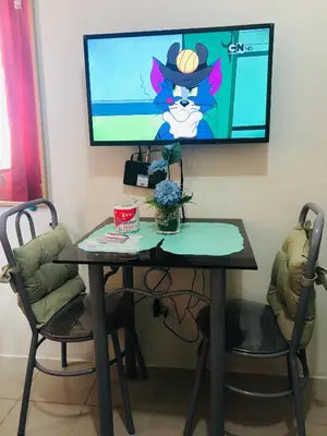 a desk with a computer and a television on a wall at Shanilyn Residency Urban Deca Towers EDSA mandaluyong Unlimited INTERNET AND NETFLIX in Manila