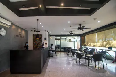 a dining room with tables and chairs in a restaurant at DG Grami Hotel in Manila