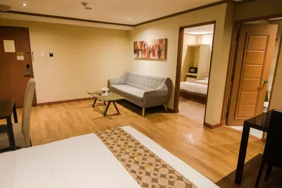 a living room with a couch and a table at DG Grami Hotel in Manila