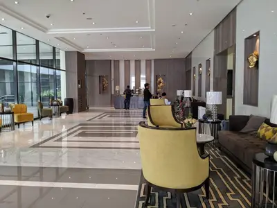 a lobby with a couch and chairs in a building at Studio Condo NAIA Airport Terminal 3 Newport City Casino in Manila