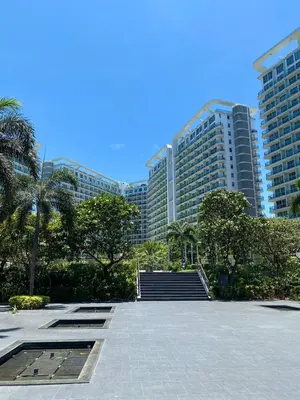 a group of tall buildings in a city with stairs at Azure Urban Resort Residences, Condo, Manila Airport, Wave-Pool, Tropical Vibe in Manila